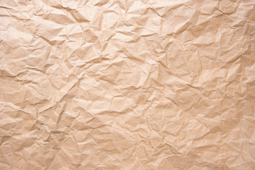 Old crumpled texture brown cardboard sheet of empty paper yellow background.