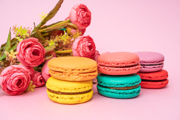 macarons with tender small roses. Sweets and desserts concept of macaroons