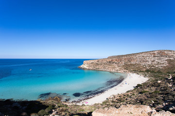 Fototapeta na wymiar Lampedusa Island Sicily - Rabbit Beach with no people and Rabbit Island Lampedusa “Spiaggia dei Conigli” with turquoise water white sand at paradise beach.