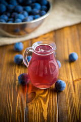 sweet compote of autumn blue plums in a glass decanter