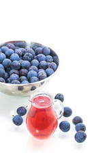 sweet compote of autumn blue plums isolated on white background