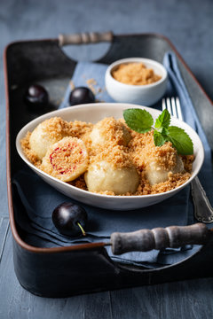 Freshly boiled plum dumplings topped with sweet toasted breadcrumbs