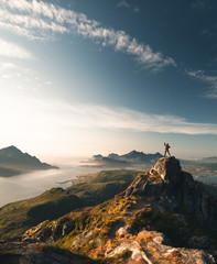 person on the summit of the mountain. Lofoten Islands. perfect golden hour
