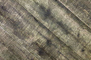 Old badly scratched boards. Wood background. Grunge style. Diagonal.
