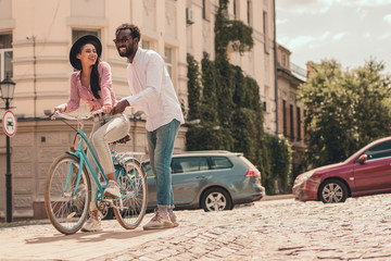 Woman sitting on the bike and man smiling stock photo