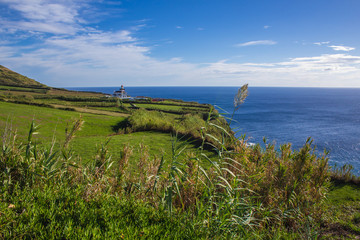 view of Farol da Ponta da Ferraria lighthouse from Miradouro da Ilha Sabrina, Sao Miguel Island, Azores, Portugal