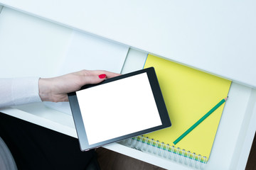 Secretary holding a tablet, Desk, open shelf, female hand, close up, top view, background, copy space, advertising