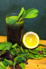Glass of fresh, homemade, healthy juice from beet leaves, spinach and wild rocket