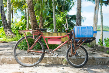 Itapissuma, Brazil - Circa July 2019: Bicycle equipped to carry and deliver water bottles in...