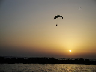 Sunset in the Mediterranean sea seen from Haifa's beach promenade, in Israel.