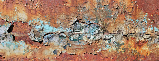 Enamelled  cracked  surface of the door hood of the old truck car was painted in yellow blue and red colors