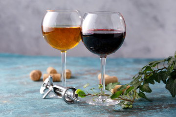 Glasses of white and red wine. The concept of winemaking. Place under your text. Still life on a textural background.