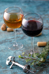 Glasses of white and red wine. The concept of winemaking. Place under your text. Still life on a textural background.