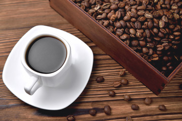 light coffee beans wooden box with coffee, natural wooden background