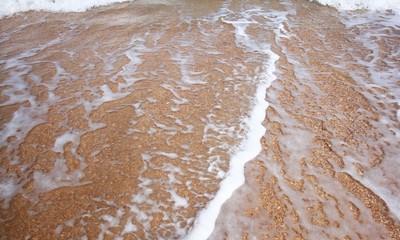 Calm waves on beach - Calm sea waves at morning time on a beach.