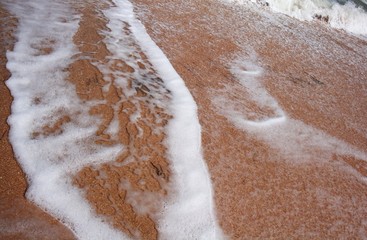 Calm waves on beach - Calm sea waves at morning time on a beach.