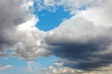 Fototapeta na wymiar Summer dramatic clouds fly across a bright blue sky.