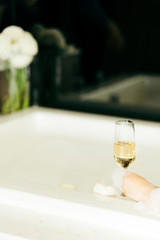 Glass of wine in bubble bath