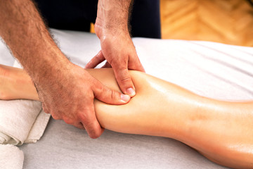 Fototapeta na wymiar Gentle massage of the calf muscle area
