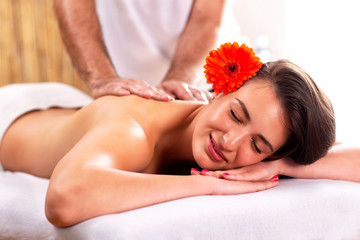 Obraz na płótnie Canvas Happy young woman enjoying her massage
