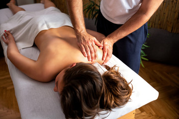 Fototapeta na wymiar Attractive woman having a shoulder massage