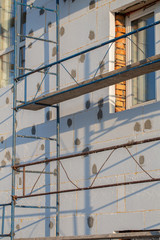 Obraz na płótnie Canvas Scaffold on house, renovation. House for renovation with the scaffolding for workers on building