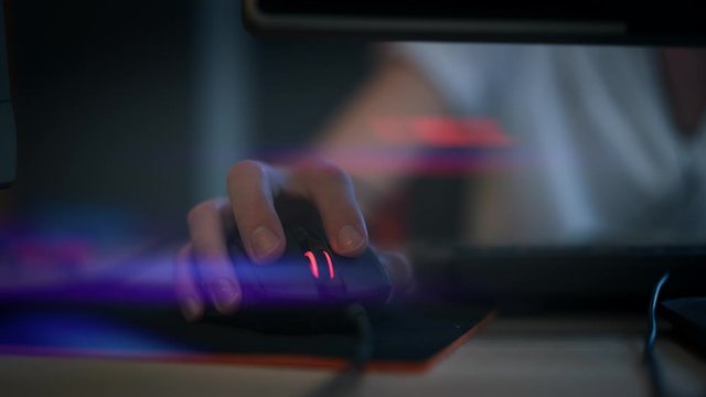 A man clicking digital mouse and working on computer. Close up hand on mouse. The concept of doing creative job. Computer lab. Cyber business. Real time shot