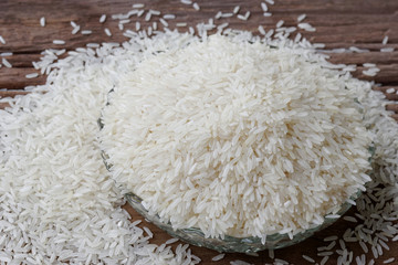 Raw rice in a Glass plate on wooden table