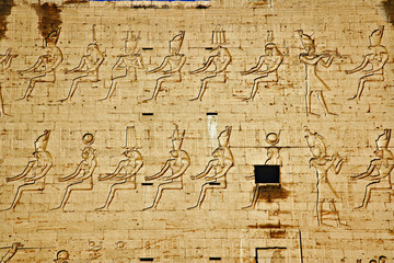 Images of Pharaohs and hieroglyphs on main pylons of entrance to Temple of Horus, Edfu, Egypt