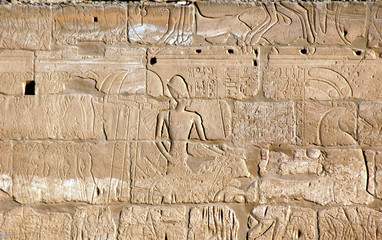 EGYPT, Luxor. Old heritage stone brick wall and its hieroglyph in the archeological site of Luxor