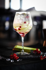 tonic gin cocktail with fresh rhubarb & red berries