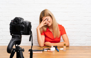 Teenager blogger girl recording a video tutorial laughing