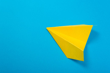 Yellow paper rockets or paper planes on a beautiful light blue background.