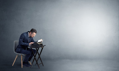 Man working hard on a typewriter in an empty space