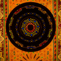 Morocco. A graphic silhouetted detail of a metal Moroccan lamp in a ceiling of a restaurant.