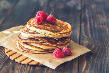 Stack of pancakes with fresh raspberries