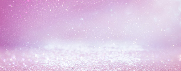 background of abstract glitter lights. purple, pink, gold and silver. de focused. banner