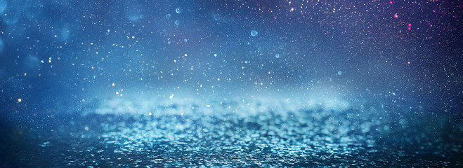 blackground of abstract glitter lights. blue, silver and black. de focused. banner