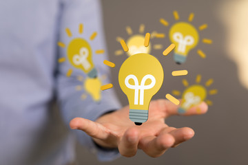  holding illuminated light bulb, idea, innovation and inspiration concept.