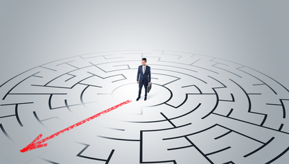 Businessman going through the maze with red arrow