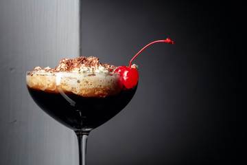 Coffee cocktail with whipped cream sprinkled with chocolate chips.