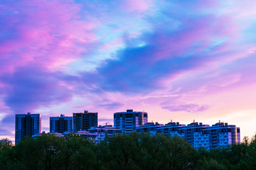 Sky at sunset with clouds in the city, apartment buildings