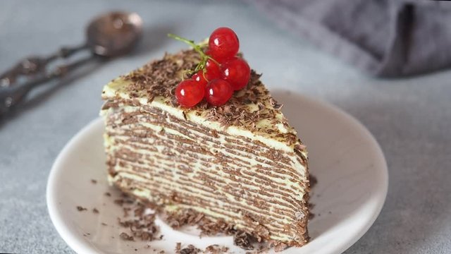 Red currant berries decorate a piece of pancake cake.