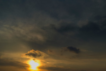 The sky at sunset. Cumulus clouds lit by the rays of the setting sun.