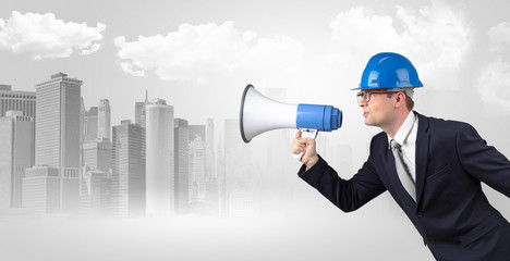 Fototapeta premium Young supervisor architect yelling to far big city panorama