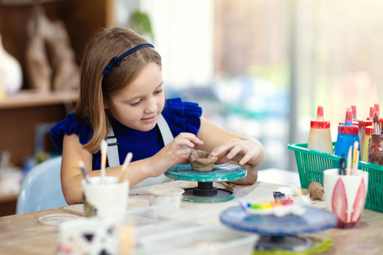 Child At Pottery Wheel. Kids Arts And Crafts Class