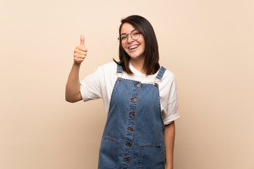 Young Mexican woman over isolated background with glasses