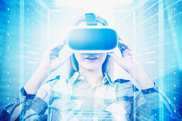 Woman in VR glasses in server room