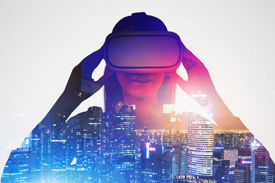 Fototapeta Astonished woman in VR glasses in night city