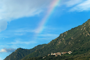 Rainbow on Santa Maria Poggio village in Corsica mountain